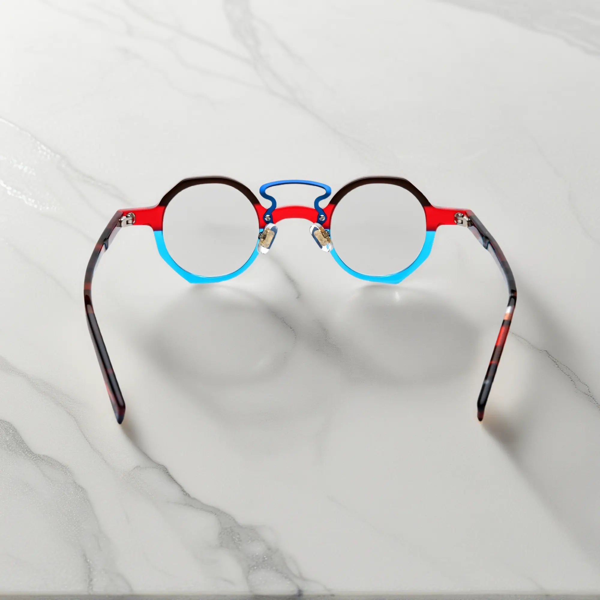 Angled close-up showing geometric shape of VoyueLens™ VL19244 Crimson Blue Fusion eyeglasses, ideal for small faces